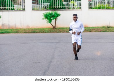 Young Black Man Jogging On The Road For Exercise