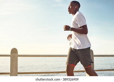 Young Black Man Jogging On Promenade Stock Photo 389326909 | Shutterstock