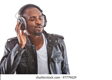 Young Black Man Listening To Music Over His Headphones.