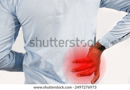 young black man with lower back pain severe backache, touching back trying to ease pain in spine, isolated on white background, backpain health and wellness, medical articles .Rear view, office sick