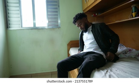 A Young Black Man Lying Down In Bed Resting