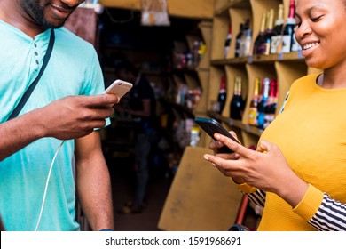 A Young Black Man Paying In A Supermarket By Doing A Transfer With His Mobile Phone