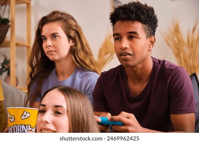 Young black man playing video games with his friends at shared student flat. - Powered by Shutterstock