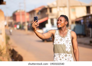 Young Black Man Raises His Phone Up A Bit Because Of Poor Reception