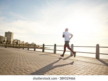 Young Black Man Running On The Promenade.