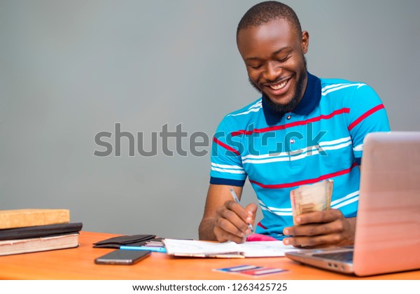 Young Black Man Sitting Desk Smiling Stock Photo Edit Now 1263425725