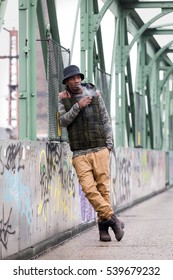 Young Black Man Smoking Cigarette On Street