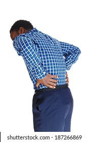 A Young Black Man Standing Isolated For White Background, Holding His  Hands On His Back For Heavy Back Pain. 