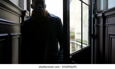 Young Black Man Stepping Outside Walking Through Corridor, Person Opening Door