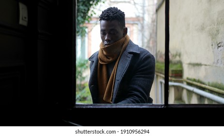 Young Black Man Stepping Outside Walking Through Corridor, Person Opening Door