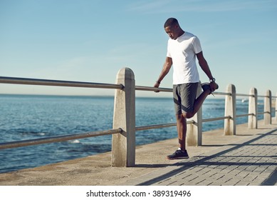 Young Black Man Stretching Before A Workout.