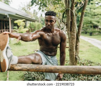 Young Black Man Stretching Leg Outdoors High Quality Photo