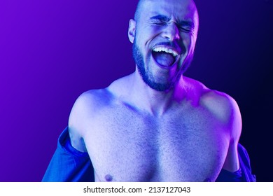 Young Black Man Takes Off The Shirt In Neon Light