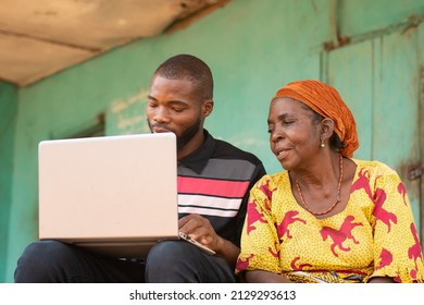 young black man talking to an old black woman using a laptop