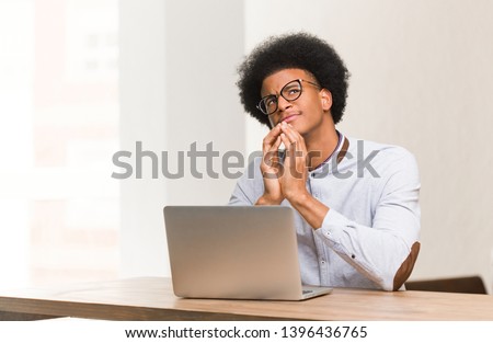 Young black man using his laptop devising a plan