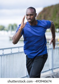 Young Black Man Wearing Athletic Wear Running Around The Lake