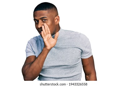 Young Black Man Wearing Casual T Shirt Hand On Mouth Telling Secret Rumor, Whispering Malicious Talk Conversation 