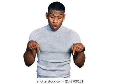 Young Black Man Wearing Casual T Shirt Pointing Down With Fingers Showing Advertisement, Surprised Face And Open Mouth 