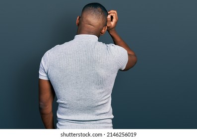 Young Black Man Wearing Casual T Shirt Backwards Thinking About Doubt With Hand On Head 