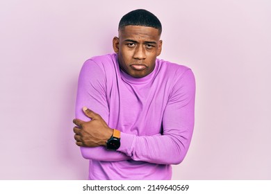 Young Black Man Wearing Casual Pink Sweater Shaking And Freezing For Winter Cold With Sad And Shock Expression On Face 