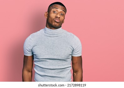 Young Black Man Wearing Casual T Shirt Looking At The Camera Blowing A Kiss On Air Being Lovely And Sexy. Love Expression. 
