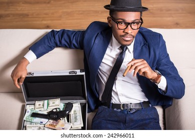 Young Black Man Is Wearing Suit And Hat With Gun And Money.