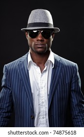 Young Black Man Wearing Suit And Hat And Sunglasses.