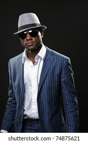 Young Black Man Wearing Suit And Hat And Sunglasses.