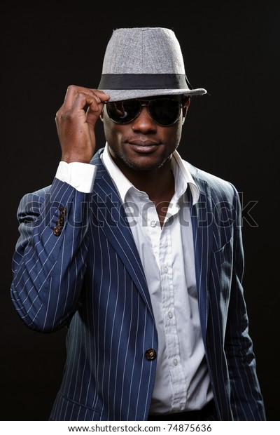 black man in suit and hat