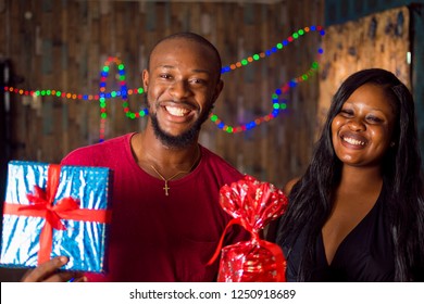 Young Black Man Woman Holding Wrapped Stock Photo 1250918689 | Shutterstock