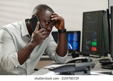 Young Black Man Working With In Stock Trading Industry Feeling Stressed Out Talking To Dissatisfied Client