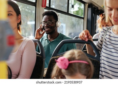 A Young Black Mas Is Listening To Music On His Headphones As He's Riding The City Bus