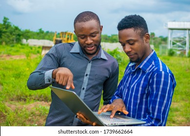 young black men discussing some business plans to be executed on a farmland