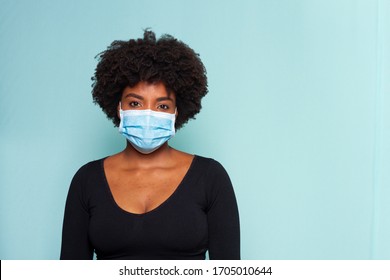 young black model wearing protective mask and black shirt and black power hair - Shutterstock ID 1705010644