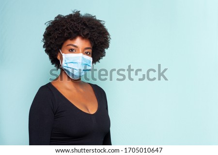 young black model wearing protective mask and black shirt and black power hair