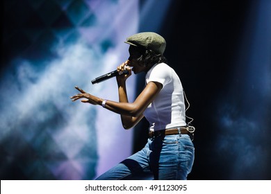 Young Black Rap Singer Girl With Microphone Performing On Concert Stage. British Rapper Little Simz Singing On Music Festival In Night Club. African Female Rapping. 
EUROPE - 29 SEPTEMBER,2016