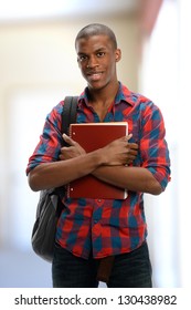 Young Black Student Holding A Copybook Isolated On A White Background