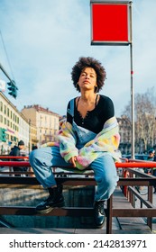 Young Black Stylish Curly Afro Hair Woman Posing Outdoor Cool Attitude And Confidence