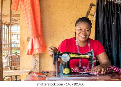 Young Black Tailor Smiling While She's Working