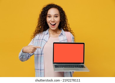 Young Black Teen Girl Student She Wear Casual Clothes Backpack Bag Show Laptop Pc Computer Blank Screen Workspace Area Isolated On Plain Yellow Color Background High School University College Concept