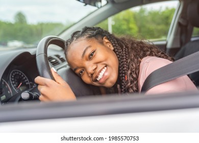 A Young Black Teenage Driver Seated In Her New Car