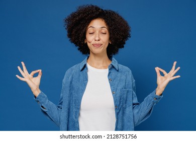 Young Black Woman In Casual Clothes Shirt White T-shirt Hold Spreading Hands In Yoga Om Aum Gesture Relax Meditate Try Calm Down Isolated On Plain Dark Blue Background Studio. People Lifestyle Concept