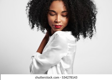 young black woman with curly hair watching down