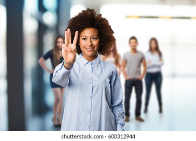 young black woman doing number three gesture