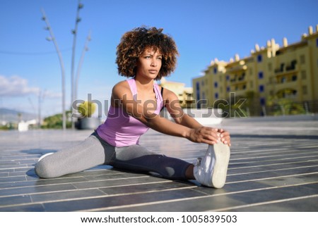 Similar – Young black woman doing stretching after running outdoors