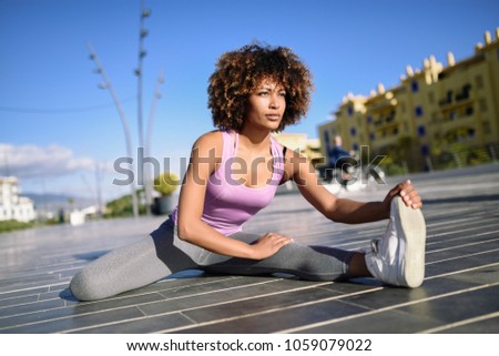 Similar – Young black woman doing stretching after running outdoors