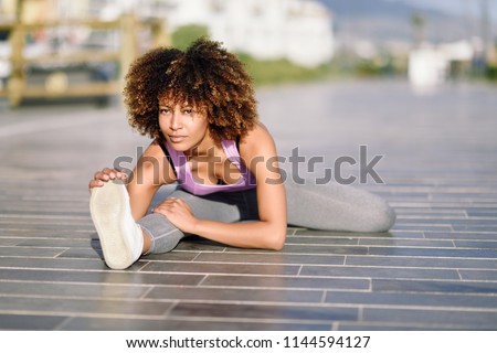 Similar – Young black woman doing stretching after running outdoors