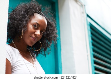 Young Black Woman In A Doorway Looking To Camera, Close Up