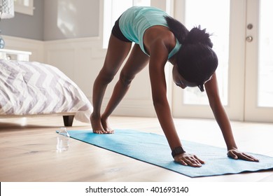 Young Black Woman In The Downward-facing Dog Yoga Pose