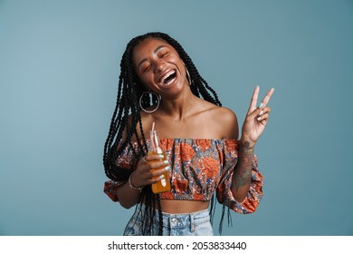 Young Black Woman Drinking Soda While Showing Peace Gesture Isolated Over Blue Background